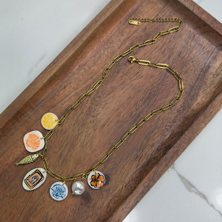 Necklace with various charms on a wooden tray