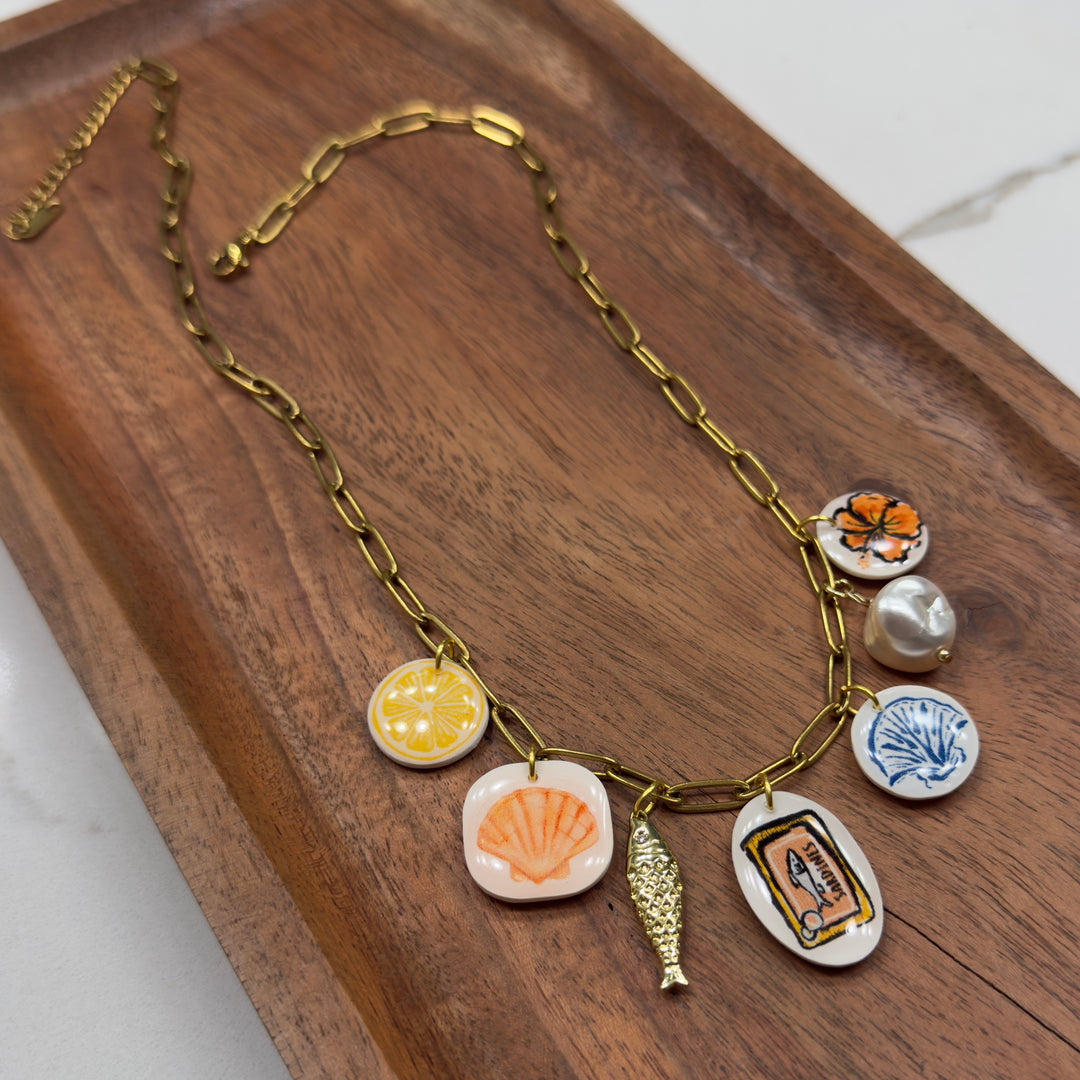 Necklace with various charms on a wooden surface