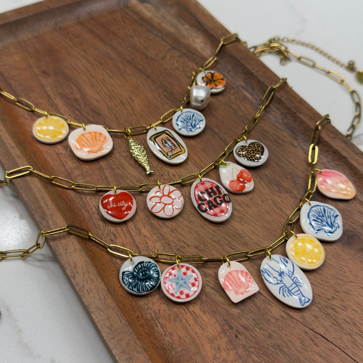 Necklace with colorful ceramic pendants on a wooden surface