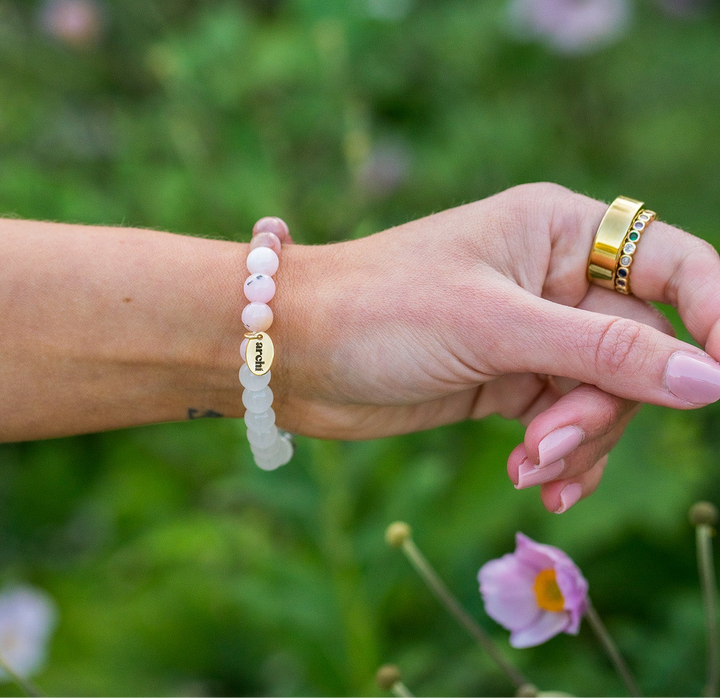 Close-up of the 18K gold-plated charm engraved with "Archi" on the Amara Self Love Bracelet