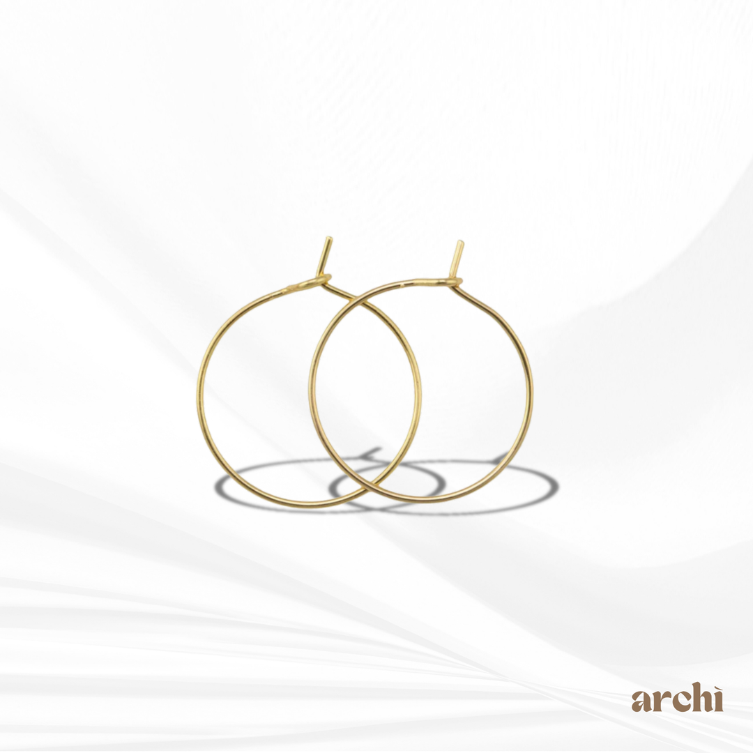 Close-up view of the latch back closure and polished gold finish on the Isla Gold Hoop Earrings.
